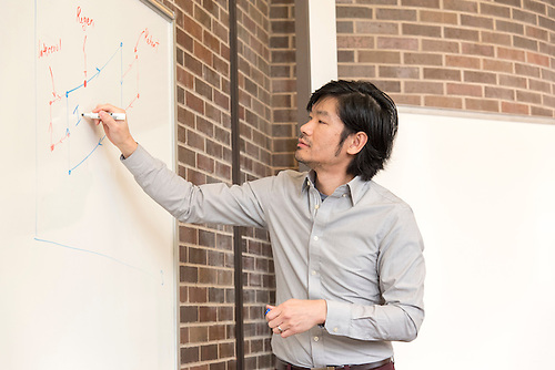 Faculty using a whiteboard